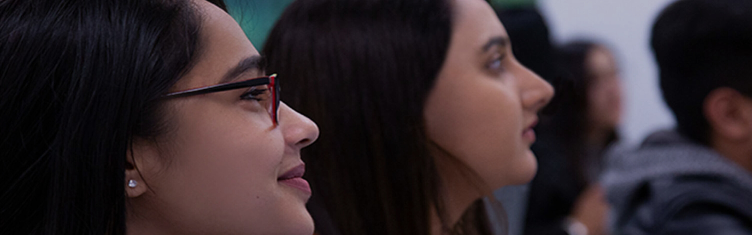 Students sitting in a classroom looking to the front of the room