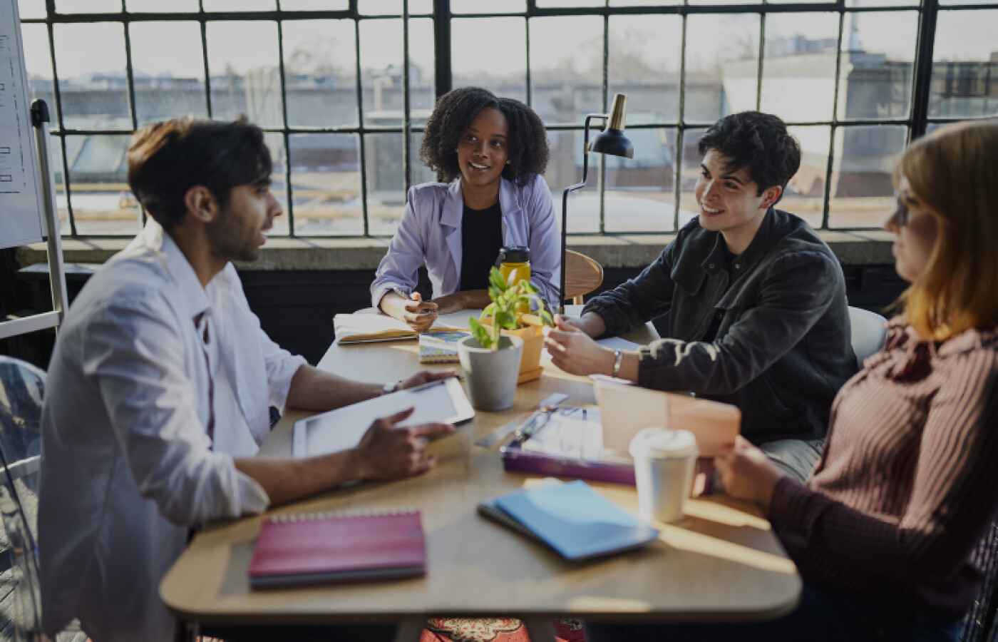 Students sitting around a table in a loft space