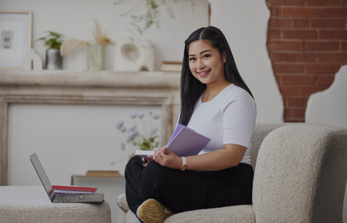 Girl sitting on couch with notebook