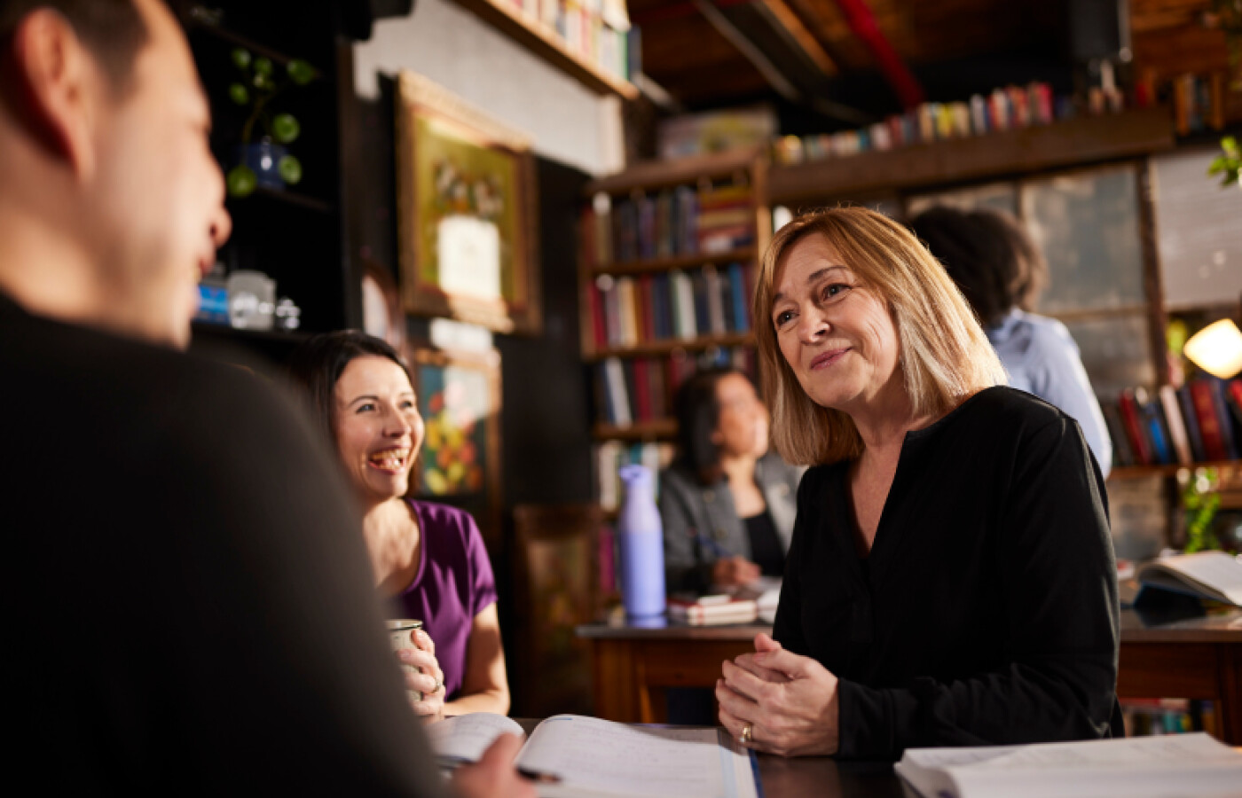 A group of adults talking together in a library