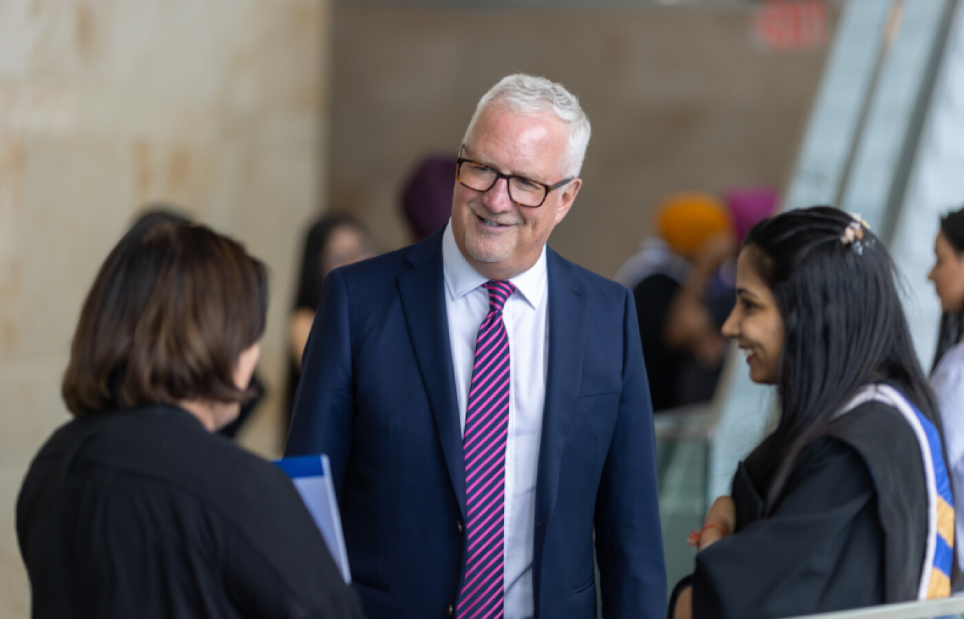 A faculty member speaking to two students