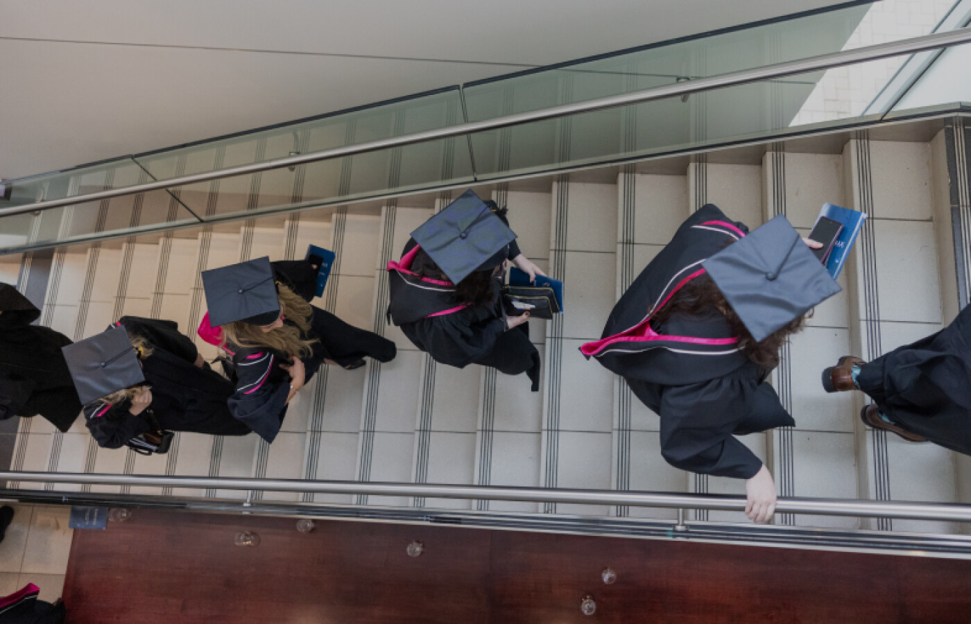 Graduates walking in a line up stairs